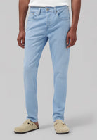 Sustainable MUD Jeans made from organic cotton, in classic blue, paired with a white shirt, showcasing ethical fashion.