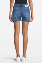 Casual blue denim shorts, worn with a black tank top, showcasing a back view with a focus on pockets and stitching details.