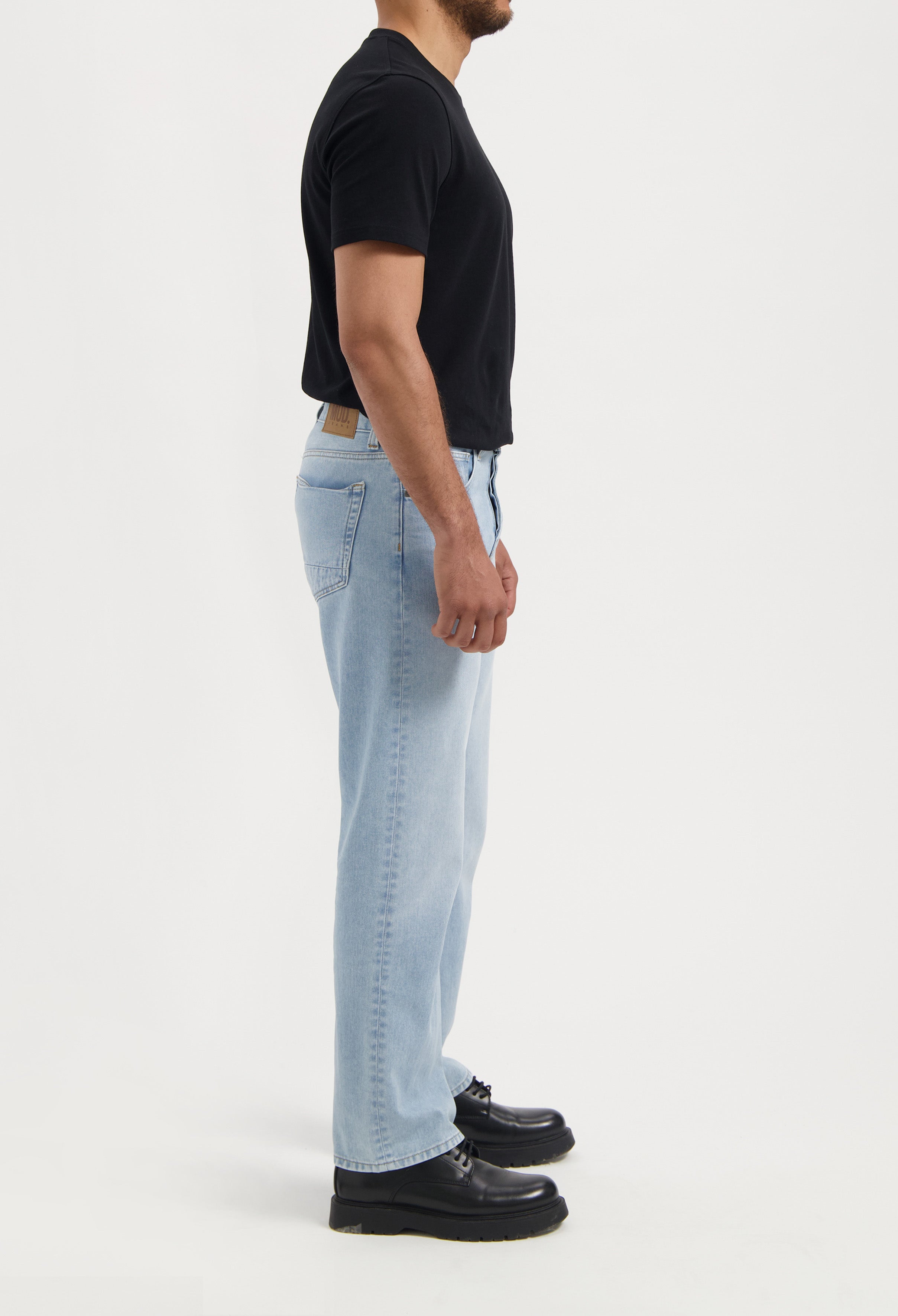 Sustainable MUD Jeans in black denim, featuring an eco-friendly design with detailed stitching and ethical craftsmanship.